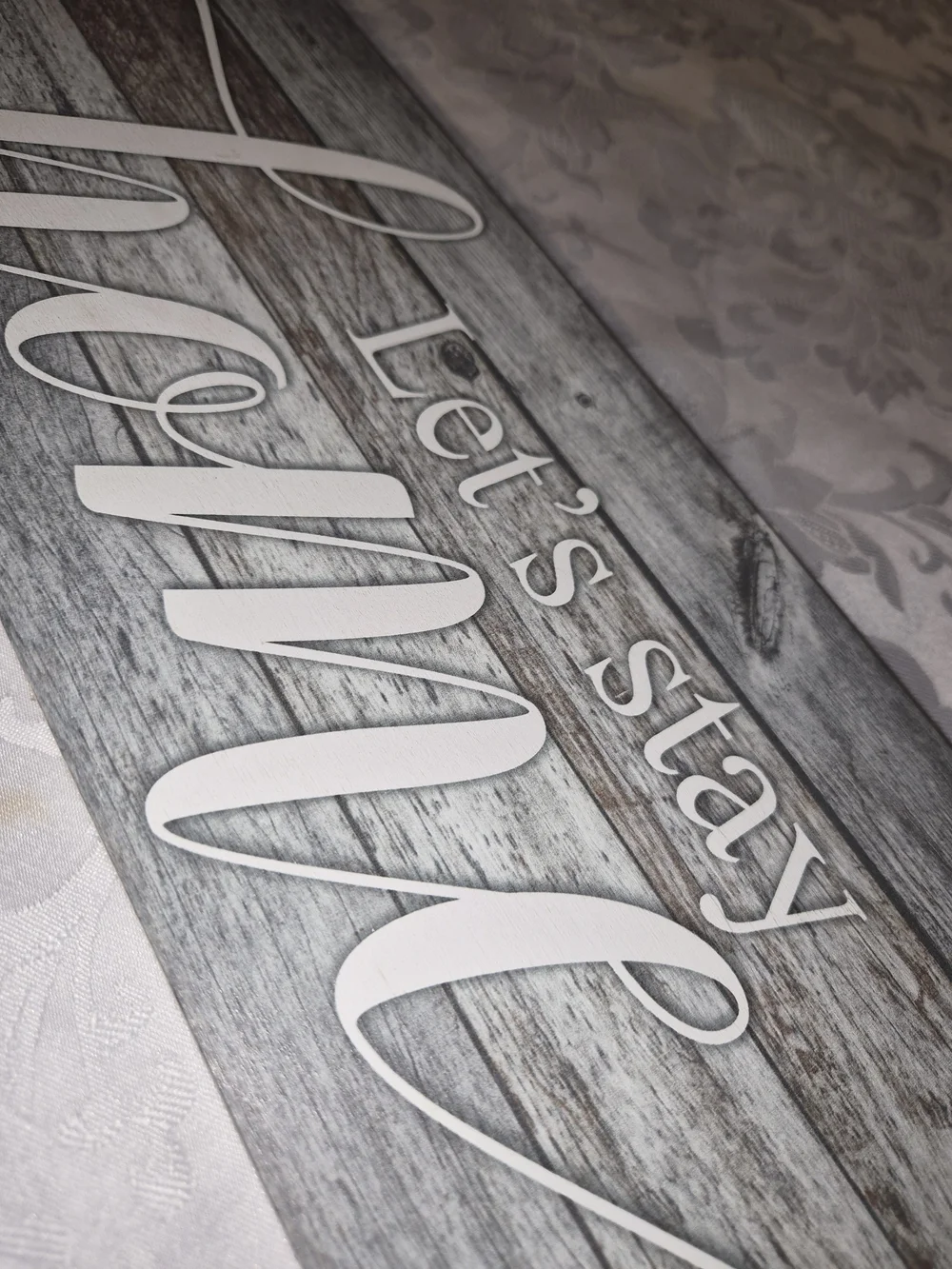 Let's Stay Home Wood Wall Sign - White on Weathered Gray